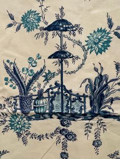 a blue and white wallpaper with an umbrella in the middle, flowers on it