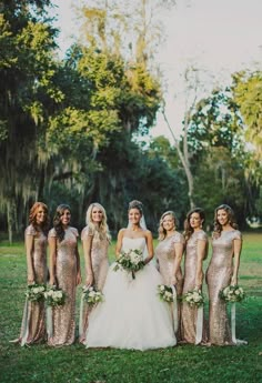 a bride and her bridesmaids in gold sequin gowns at their wedding