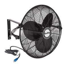 a black fan sitting on top of a white wall