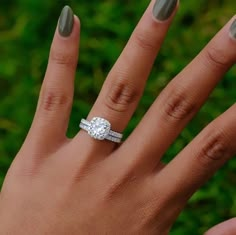 a woman's hand with two wedding rings on her left and the middle finger