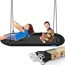 two children are playing on swings with the straps attached to them and one child is smiling