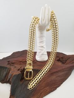 "Cool gold link belt. The belt fastens with a buckle and since it is chain you can buckle at whatever length you choose.  The base of the belt is gold links with gold metallic fabric woven through links. This belt would look great with an over-sized shirt, dress, t-shirt.  The belt measures between 43\" long 1\" 3/8 wide.  Just want to mention all my pieces are vintage I do not know the history of their life before me.  I inspect them all before posting them and let you know of any damage I see. Link Belt, Dress T Shirt, Gold Link, Metallic Fabric, Gold Fabric, Suspender Belt, Fabric Belt, Vintage Pieces, Vintage Accessories