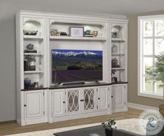 the entertainment center is white and has glass doors on each side, along with shelves