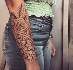 a woman with a rose tattoo on her arm