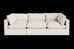 a white couch sitting on top of a white floor