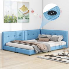 a blue bed sitting on top of a hard wood floor next to a white wall