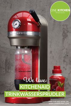 a red kitchen appliance with the words we love kitchen aid trinkwassersprudier