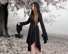 Step into an enchanting realm of style and sophistication with our meticulously crafted Black Hooded Witch Gothic Dress. Designed with a touch of dark allure and a dash of Renaissance inspiration, this dress is bound to make you the center of attention wherever you go. Here's why our dress deserves a place in your wardrobe: ✓ Unveil Your Elegance: Draped in the richness of black, this dress exudes an air of nobility that complements your personality. The captivating asymmetrical design, coupled Medieval Long Sleeve Halloween Dresses, Medieval Long Sleeve Dresses For Halloween, Black Long Sleeve Medieval Dress For Fantasy Events, Fitted Long Sleeve Medieval Dress For Halloween, Hooded Dresses For Winter Costume Party, Gothic Long Sleeve Medieval Dress For Halloween, Gothic Medieval Dress With Long Sleeves For Halloween, Gothic Long Sleeve Dress For Fantasy Events, Witchy Dresses For Costume Party In Fall