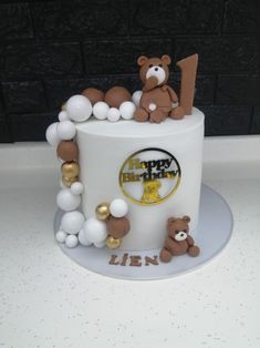 a birthday cake decorated with teddy bears and balloons