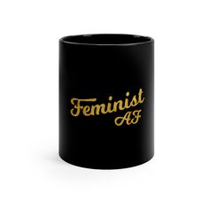 a black mug with the words feminist as on it