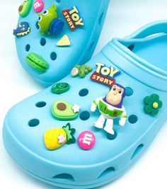 Toy story inspired crocs charm 16 piece Set Personalize you Crocs or Croc-like shoes and silicone bracelets with these stylish shoe charms. Size: Varies between each charm. Measures about 1-1.5 inches. EASY INSTALL: Slightly stretch the hole of your croc with your finger, insert charm, then release and you're all set! Payment Info: No Refund/exchanges on purchases. If there are any complications with your order please contact me. *Current production time is (1-2 days). This does NOT include ship Crocs With Charms, Crocs Charm, Kids Crocs, Tutu Outfits, Silicone Bracelets, Croc Charms, Out Of Reach, Shoe Clips, Charm Set