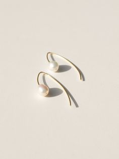 These classic threader earrings are so versatile, they can be dressed up for bridal ware or dressed down with a summer dress or pair of jeans. Beautifully imperfect and full of grace, just like the grit in the oyster. Wear it as a symbol of perseverance and wisdom accumulated through life's ample trials and tribulations. Triple plated premium brass over 925 sterling silver for superior tarnish resistance Hypoallergenic and nickel free 1 3/4" total length Cultured freshwater baroque pearl Sustain Elegant Summer Dangle Hoop Earrings, Elegant Summer Wedding Pearl Earrings, Elegant White Drop Threader Earrings, Classic Long Drop Pearl Earrings With Ear Wire, Elegant Drop Earrings With Fish Hook, Delicate Summer Jewelry With Matching Earrings, Elegant Jewelry With Fish Hook For Gift, Minimalist Sterling Silver Earrings For Summer, Pearl Earrings With French Hook For Gift