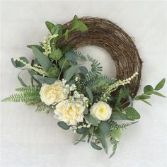 a wreath with white flowers and greenery