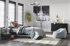 a bed room with a neatly made bed next to a window and a painting on the wall