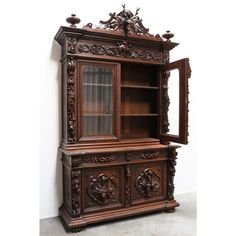 an ornate wooden cabinet with glass doors