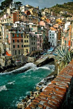 a river running through a city with lots of buildings on the hillsides above it