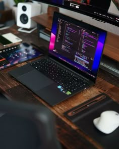 a laptop computer sitting on top of a wooden desk next to a mouse and keyboard