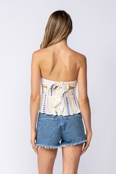 Nothing is as perfect as a sunshine-filled day and the Amelia White Embroidered Strapless Top! Lightweight, woven fabric shapes this ideal summer top that features a white embroidered print throughout as it shapes a strapless bodice that wraps around and ties in the back, a smocked waist, and flouncy, slightly cropped peplum hem. DETAILS & CARE Rayon/LINING: Polyester. Hand Wash Cold. Imported. ORDERS, SHIPPING & RETURNS Orders, Shipping, & Returns Strapless Fitted Crop Top For Summer, Fitted Strapless Crop Top For Summer, Spring Smocked Bodice Bandeau Crop Top, Bohemian Fitted Strapless Crop Top, Fitted Bohemian Strapless Crop Top, Fitted Strapless Bohemian Crop Top, Summer Off-shoulder Crop Top With Smocked Bodice, White Strapless Halter Top, Summer Cotton Tube Top