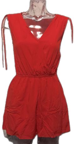 Trendy Red Jumpsuits For Summer, Trendy Red Jumpsuits And Rompers For Summer, Casual Red V-neck Jumpsuit, Casual Red V-neck Jumpsuits And Rompers, Red Jumpsuits And Rompers For Summer Day Out, Red Cotton Summer Jumpsuits And Rompers, Red Beach Jumpsuit With Pockets, Red Jumpsuits And Rompers With Pockets For Beach, Chic Red Jumpsuits And Rompers For Vacation