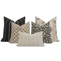 four pillows with different patterns on them, one in black and the other in white