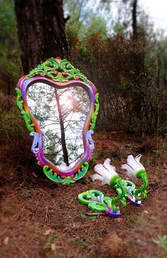 This beautiful vintage mirror and sconces set would look great anywhere in your hallway, living room or bedroom. The frame is hand carved solid wood and was originally made in a dark brown varnish in the 1970s. I removed all the old paint and varnish and revamped it by hand painting it in vibrant green, pink, purple, yellow and orange. The sconces were originally not part of the mirror but I painted them to match and they look perfect together. The result is a funky yet classic mirror and lamps Fairy Mirror, Home Maximalist, Mirror And Sconces, Maximalist Boho, Rainbow Mirror, Colorful Mirror, Hand Painted Frames, Classic Mirror, Perfect Together