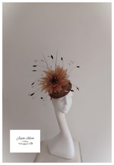 Make an entrance with this chestnut brown button base fascinator.  An abundance of coffee coloured  goose feathers take centre stage on this striking piece, with dancing coq feather tips in champagne and dark chocolate.  A coffee starburst feather flower adds a dramatic effect, with contrasting chocolate goose biot, whilst a pair of chestnut quills reach for the sky.  A firework finale created  with exploding ivory pearls adds the perfect finish.  Sits on a headband. ''This item has sold, howeve Royal Ascot Hats, Ascot Hats, Wedding Fascinators, Feather Flower, Goose Feathers, Centre Stage, Royal Ascot, Ivory Pearl, Chestnut Brown