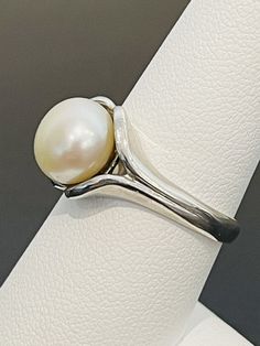 This is a classic and timeless look. Pearls have become en vogue again and this is a ring that would appeal to most women. Great for work or everyday. This ring is made in sterling silver and is a size 8. This pearl is 10 mm. White Pearl Ring, Feminine Wardrobe, Glendale Az, Dragon Ring, Pearl And Diamond Ring, Moonstone Ring, Pearl Ring, White Pearl, Pearl White