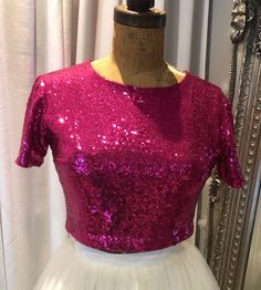 Wedding Sequin top Cerise pink, bridal or bridesmaid top. Sequin covered cropped bridal top with short sleeves. This item has a high front and back neckline,it is a cropped length to sit just above the natural waistline, but can be made to any desired length. This top is made from sequin stretch fabric and lined with a soft ivory jersey fabric. This top is made to be quite fitted but if you desire a loser fit just let me know.    If you require this top in any other colours or different fabric p Pink Cropped Top For Evening, Pink Evening Crop Top, Elegant Pink Evening Crop Top, Elegant Pink Crop Top For Evening, Pink Cropped Blouse For Party, Pink Fitted Crop Top With Short Sleeves, Fitted Pink Crop Top With Short Sleeves, Pink Crop Top Blouse For Party, Pink Summer Evening Crop Top