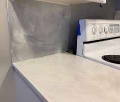 a white stove top oven sitting inside of a kitchen