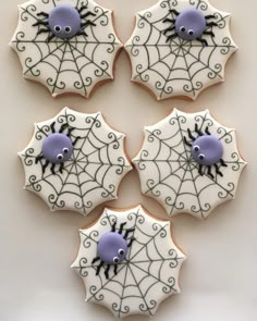 decorated cookies in the shape of umbrellas with spider web designs on them for halloween