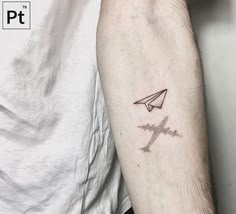 a person with a tattoo on their arm that has an airplane and the word love