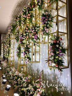 the wall is decorated with flowers and greenery