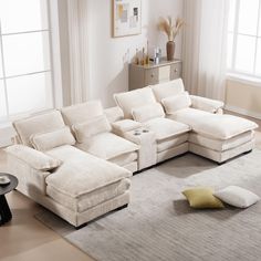 a living room with a sectional couch and pillows