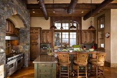 a large kitchen with wooden cabinets and an island