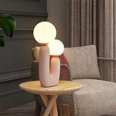 a table with a lamp on it next to a chair