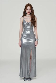 Radiate confidence in our Metallic Sheen Slip Dress, designed for a sleek and bold statement.
Made with a blend of polyester and spandex, this dress offers a comfortable fit with a touch of stretch, perfect for accentuating your silhouette. The thigh-high split adds a flirtatious edge to the elegant shape, while the subtle shimmer of the metallic fabric ensures you stand out in any setting.
Pair this slip dress with strappy heels for a glamorous evening look, or layer it with a tailored blazer f Fitted Silver Evening Dress, Sleek Fitted Evening Dress For Spring, Modern Fitted Maxi Dress For Party, Class Dress, Pose References, Metallic Fabric, Tailored Blazer, Maxi Gowns, Urban Wear