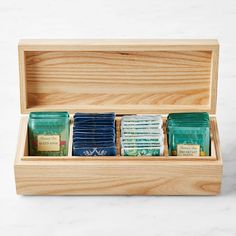 a wooden box filled with soaps on top of a table