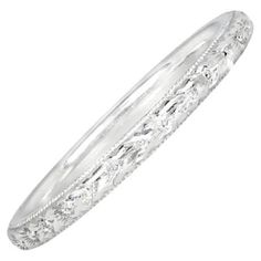 A stunning handcrafted wedding band, meticulously designed with intricate hand-engravings inspired by the elegance of the Art Deco era. Crafted from luxurious platinum, this exquisite band showcases fine milgrain detailing along its edges, enhancing its timeless appeal. Measuring 2mm in width, it offers a delicate yet sophisticated look, perfect for those who appreciate vintage-inspired artistry and exceptional craftsmanship. Designed to be unisex, this band is available in any finger size, ensu Elegant Carved White Gold Rings, Elegant Silver Carved Engraved Ring, Elegant Engraved Ring For Ceremonial Occasions, Ceremonial Wedding Rings With Decorative Band, Heirloom Engraved Carved Ring For Wedding, Heirloom Carved Engraved Ring For Wedding, Formal Etched Round Band Rings, Carved White Gold Rings For Formal Occasions, Ornate Carved Engraved Ring For Anniversary