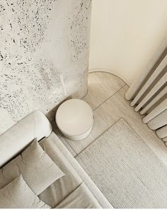 a white toilet sitting in the corner of a room next to a radiator