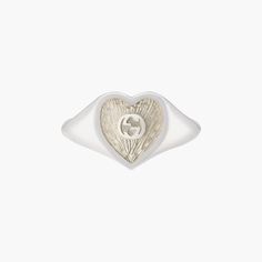 Sterling silver Gucci heart signet ring with white mother-of-pearl enamel. In the center of the Enamel the interlocking G logos is raised. The top of the ring is 0.04" in size. Mother Of Pearl Signet Ring, Gucci Sterling Silver Ring, Classic Gucci Engraved White Gold Ring, Engraved White Gold Gucci Jewelry, Classic Gucci Engraved Ring For Anniversary, Classic Gucci Engraved Ring For Gift, Classic Gucci Engraved Ring As Gift, Gucci White Gold Sterling Silver Ring, Gucci Sterling Silver Ring For Formal Occasions