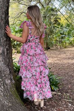 DESCRIPTION The Dress in Pink is a beautiful addition to any wardrobe. Made from floral printed. this tiered dress exudes effortless elegance. Perfect for any occasion. it's a must-have for those who want to make a statement with their style. DETAILS: Tie up detail on shoulder Floral print design Tiered ruffled hem Midi length Model is wearing size small. Product Measurements  Length  Bust  Waist   Label Size  US Size  IN  IN  IN   XS  2  44.29  29.13  25.98   S  4  44.88  30.71  27.56   M  6  4 First Day Outfit, White Prom Dress, Floral Print Design, Bridal Shower Dress, Shower Dresses, Jumpsuits And Romper, Graduation Outfit, Feather Dress, Fringe Dress