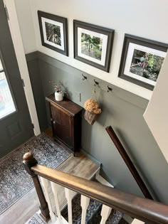 stairs with pictures hanging on the wall next to each other in a home's entryway