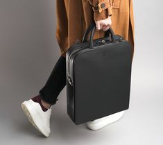 "This 10L bag is the perfect combination of style and function. Crafted from the finest leather, this bag features two main compartments, one with a zip closure and one with a magnetic closure for easy access. The timeless and minimalist design adds an extra level of sophistication to whatever outfit you wear. The adjustable shoulder strap ensures that it fits comfortably and securely on your body. The attention to detail put into this bag makes it a truly luxurious item. Each bag comes with its Tote Leather Bag, Ipad Organizer, Mac Book Pro, Body Features, Laptop Briefcase, Laptop Tote, Mac Book, Bag Interior, Laptop Rucksack