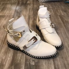 These Are Super Cool! Never Worn White Booties With Silver Buckles And Studs, Still Has Plastic Wrap Around Some Of The Buckles. White Ankle-high Summer Boots, Trendy White Closed Toe Boots, Trendy Flat Boots For Spring, White Round Toe Summer Boots, Chic White Boots With Flat Heel, Chic White Flat Heel Boots, White Booties, Plastic Wrap, Shoes White