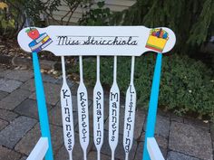 a chair made out of wooden spoons with the words miss suchida on it