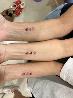 two people with matching tattoos on their arms, both have stars and moon tattoo designs