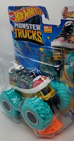 a toy truck with monster wheels in its package