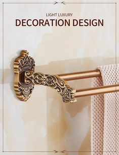 a gold towel rack with decorative design on it