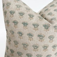 a close up view of a pillow with blue flowers on it's back side