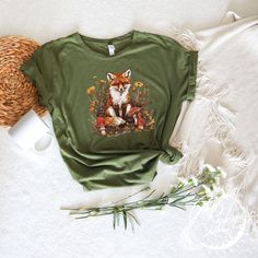 All Rocket Moon Apparel T-Shirts are printed using direct-to-garment (also known as DTG). In addition, our inks are water-based and eco-friendly. This makes the feel much softer than traditional screen printed shirts, but just as durable. Comfort Colors Fox T-Shirt, Botanical Vintage Style Tee, Boho Tee, Forestcore Shirt, Botanical Forest Animals, Fox Lover Gift For Woman **All sales are final and we don't accept returns. If we made a mistake we will send a replacement.** The best way to get the size you need is to measure a shirt that fits you or your child best and get a similar length and width using the size chart. VERY IMPORTANT PLEASE READ -->  Please note that the women's tees are fitted - depending on your preference, you may want to order a size up or purchase a unisex tee (which Fox Gifts, Fox Clothes, Screen Printed Shirts, Botanical Vintage, Fox Lover, Boho Tees, Made A Mistake, Screen Printing Shirts, Gift For Woman